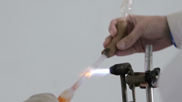 Work with glass over fire. The glass split over the caste. The lab assistant sets the burner on fire — Stock Video