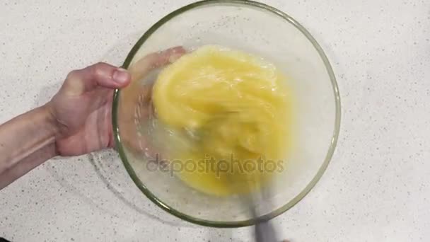 The cook stirs eggs for the cake. Whisk in glass bowl of raw egg — Stock Video