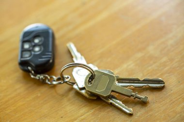 Keys with remote on wooden texure, background, Close up & Macro shot, Selective focus