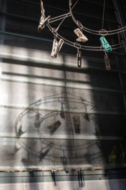 Stainless steel and plastic circle clothespin, Dusty mirror Window background, Light & Shadow, Laundry work concept