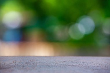Boş ahşap masa dokusu, yeşil bahçe bulanık bokeh arka plan, seçici odak