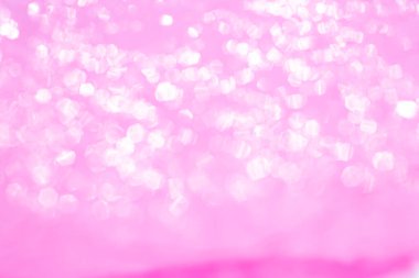 Bokeh blurred thin sheet of pink colour cellophane with shiny crumpled surface texture on white background, Abstract, Light & Shadow concept