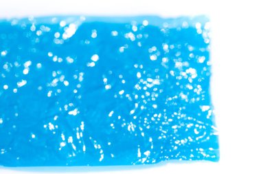 Bokeh blurred thin sheet of blue colour cellophane with shiny crumpled surface texture on white background, Abstract, Light & Shadow concept
