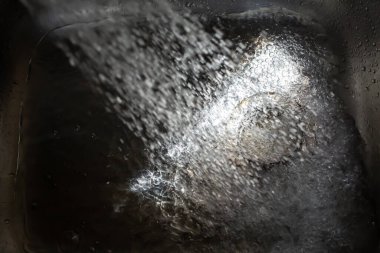 Water flowing and splashing in sink, Light and shadow, Close up & Macro shot, Selective focus, Healthcare concept