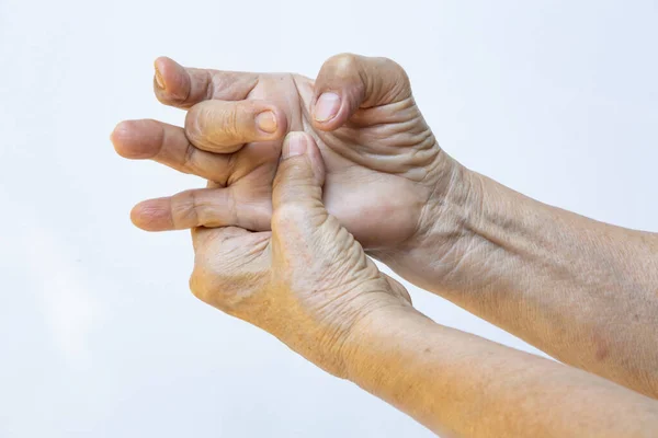Trigger Finger lock on middle finger, Senior woman's left hand massaging her right hand Suffering from pain on white background, Close up shot, Office syndrome, Healthcare, Massage, Asian body concept — Stock Image Trigger Finger Lock Middle Finger Senior Woman Left Hand Massaging Stock Image