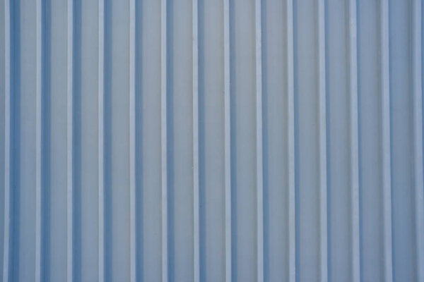 Blurred corrugated metal wall, Shiny steel fence, detail of a wall lined with metal