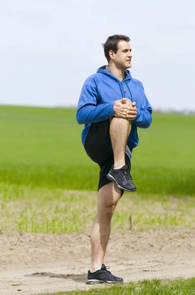 Man stand and stretch the leg — Stock Photo, Image