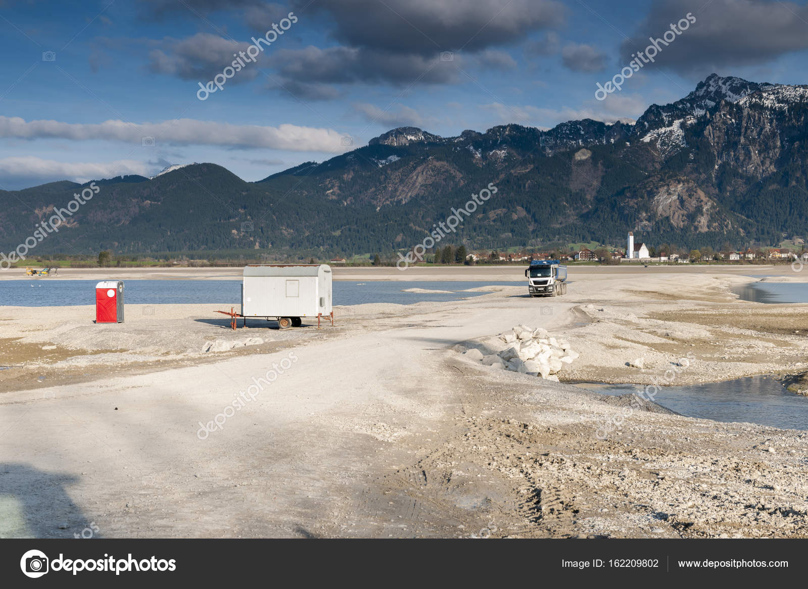 Empty Forggensee With Construction Vehicle And Toilet House