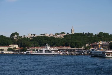 Ferry near Galata Bridge and the Golden Horn, with Topkapi Palace, in Istanbul, Turkey