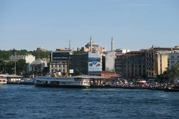 Ferry perto da Ponte Galata e do Chifre de Ouro, com Hagia Sophia, em Istambul, Turquia — Fotografia de Stock