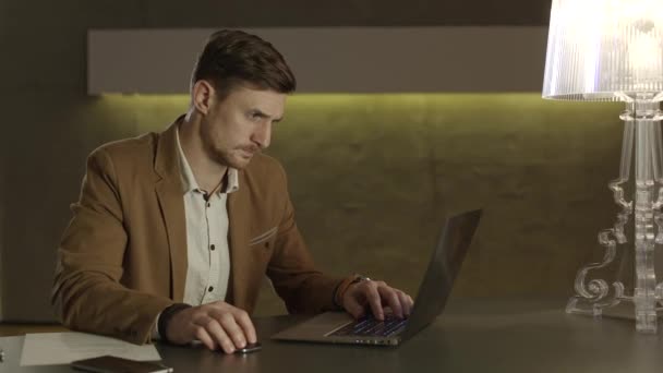 Businessman looking with interest at his laptop computer. — Stock video