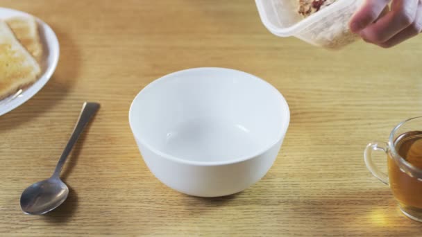 Putting Muesli into a Bowl — стоковое видео