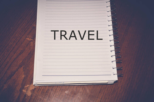 Travel word written on white paper