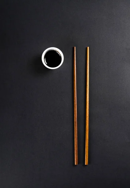 Chopsticks with soy sauce in a small cup Stock Image
