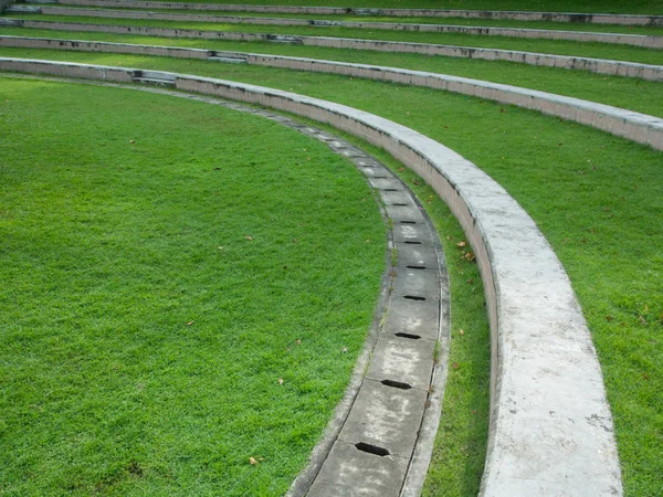 Outdoor green yard in the park stairs curve line patten from but — Stock Photo, Image