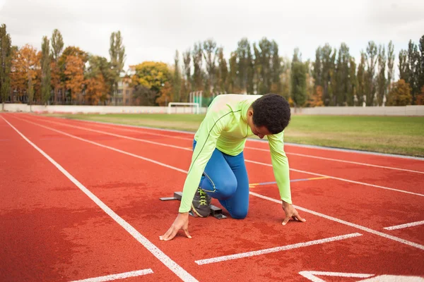 Young sporty man are ready to run on racetrack. Fit well formed people  at large nice modern stadium — Stock Photo, Image