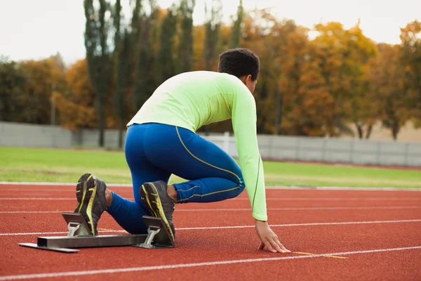 Young sporty man are ready to run on racetrack. Fit well formed people  at large nice modern stadium — Stock Photo, Image