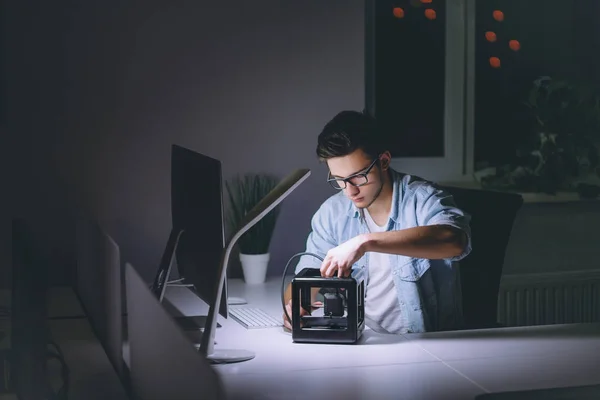 Junger Mann arbeitet nachts im dunklen Büro am Computer — Stockfoto