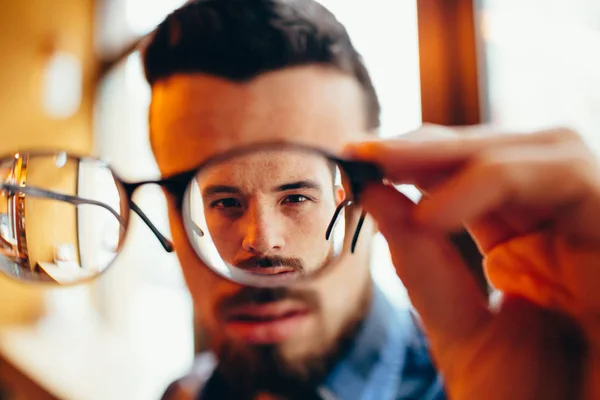 Närbild porträtt av ung man med glasögon, som har problem med synen — Stockfoto