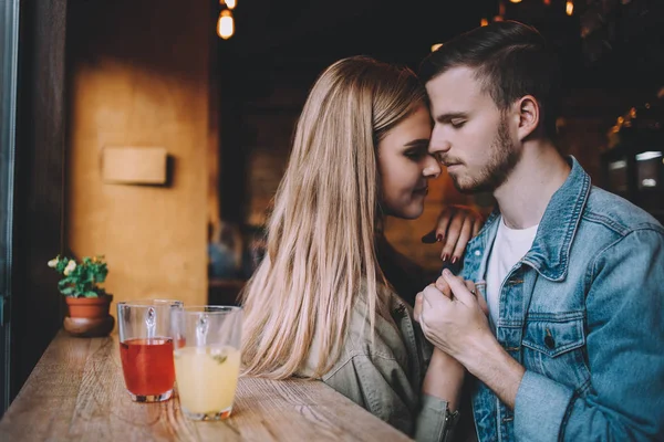 Retrato de una hermosa pareja joven enamorada en una cafetería . — Foto de Stock