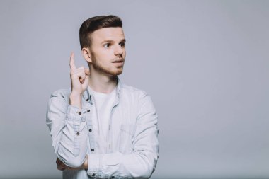 Beyaz gömlekli sakallı genç adam gülümseyen ayakta