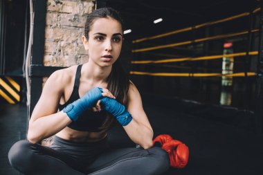 Spor salonunda sert çalışmadan sonra katta oturan genç kadın.