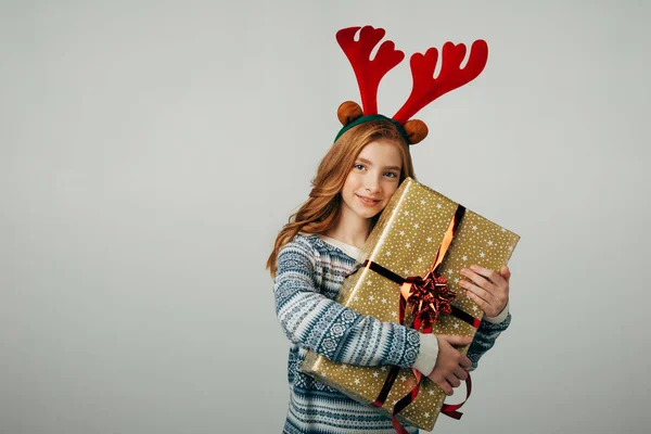 Chica pelirroja abraza su regalo de los padres en Navidad. La señora de ojos azules está feliz por el regalo de Año Nuevo de sus mejores amigos. Aislado sobre un fondo blanco . Imágenes De Stock Sin Royalties Gratis