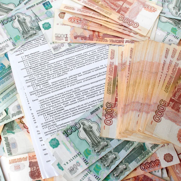 Bank deposit contract on the background a large number of rubles. — Stock Photo, Image