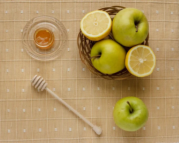 Floral honey and a basket of green apples on a textile tablecloth. Glass saucer and wooden spoon, kitchen utilities. Home made organic mask ingredients. Healthy eco lifestyle. Food blog illustrations.