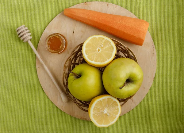 Floral honey and a basket of green apples on a textile tablecloth. Glass saucer and wooden spoon, kitchen utilities. Home made organic mask ingredients. Healthy eco lifestyle. Food blog illustrations.