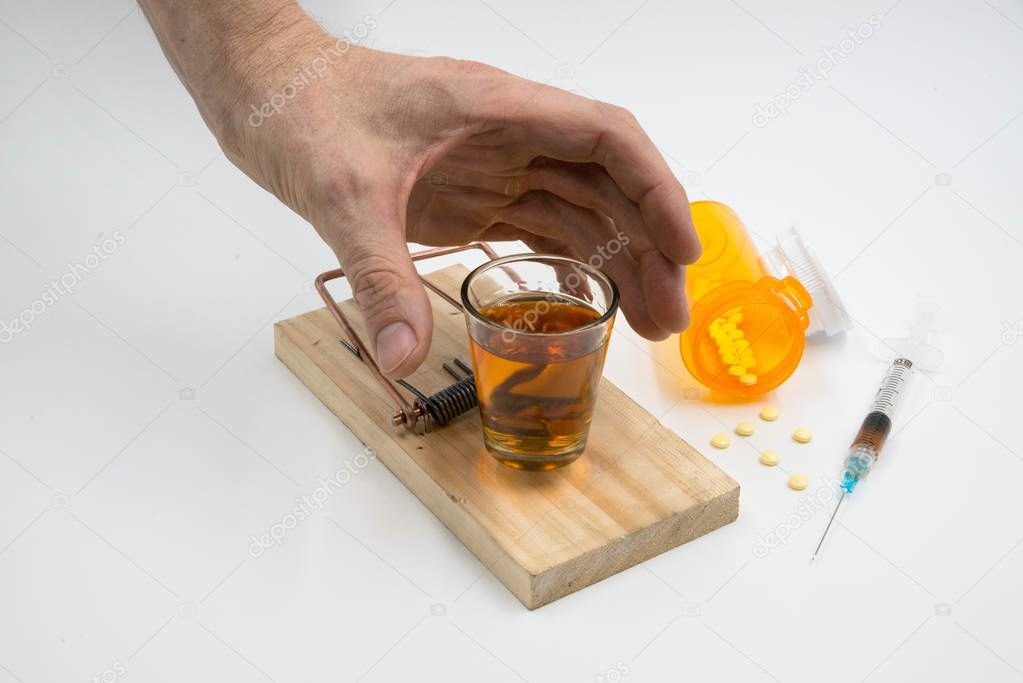 Drug Trap hand over shot glass