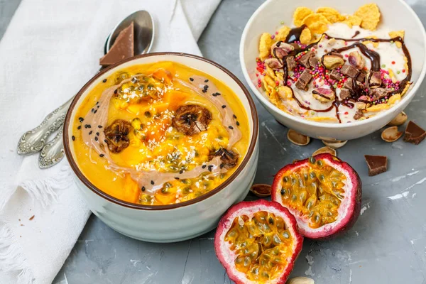 Vegan breakfast: smoothie bowls with chocolate and tropical fruits