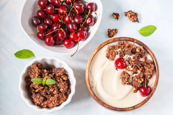 Smoothie bowl with chocolate muesli and cherry