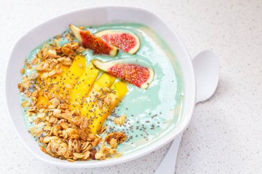 Mavi spirulina güler yüzlü kâse gevrek, mango ve incir