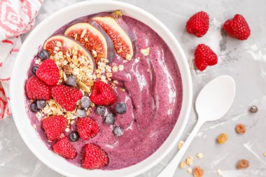 İncir, ahududu ve grano ile güler yüzlü kase (yaban mersini, acai)