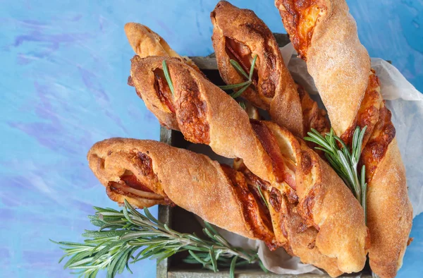 Tasty cheese sticks with bacon, herbs in wooden box. — Stock Photo, Image