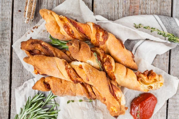 Tasty cheese sticks with bacon, herbs and tomato sauce.