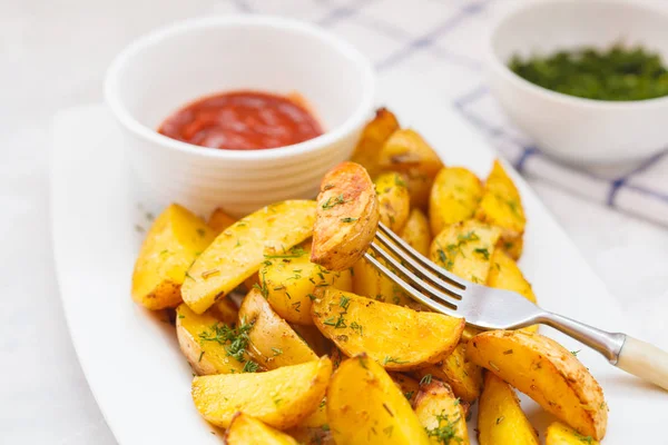 Baked potato slices with herbs in a white dish