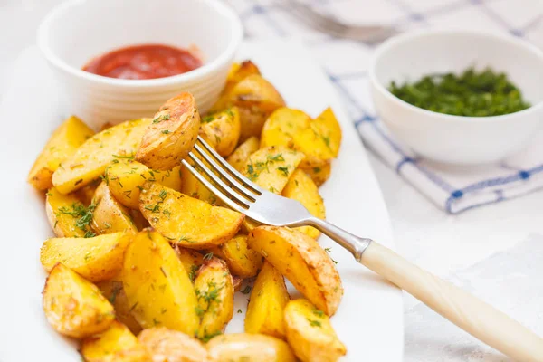 Baked potato slices with herbs in a white dish