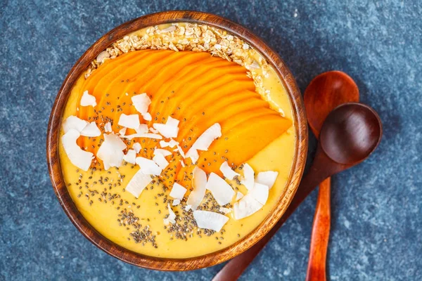 Healthy breakfast mango smoothie bowl with chia seeds, mango sli