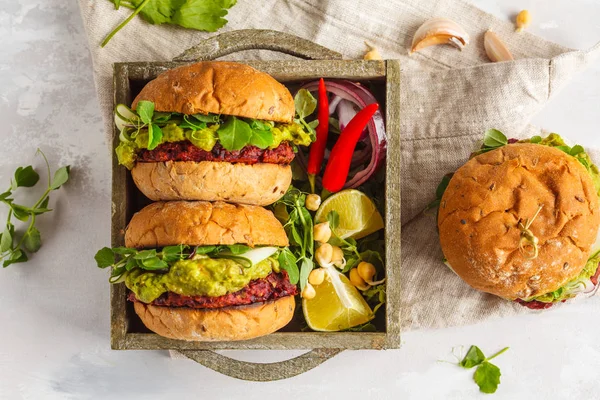 Vegan beet chickpea burgers with vegetables, guacamole