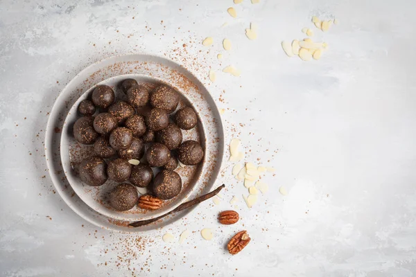 Vanilla-chocolate raw vegan sweet balls with nuts, dates and coc