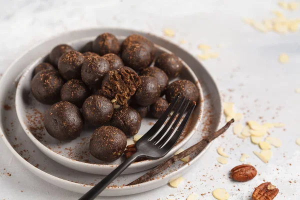 Vanilla-chocolate raw vegan sweet balls with nuts, dates and coc