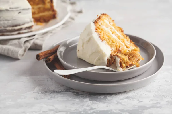 Piece of carrot homemade cake with white cream (cream cheese) on