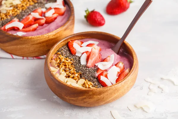 Vegan breakfast concept. Strawberry smoothie bowl with almonds,