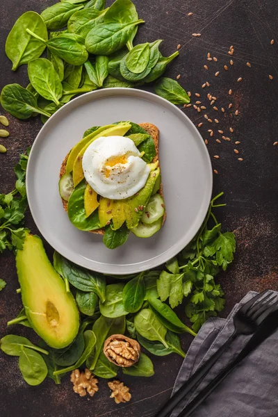 Fresh avocado breakfast with egg poached sandwich.