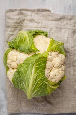 Bir peçete üzerinde hafif bir arka plan üzerinde olgunlaşmış tüm çiğ karnabahar