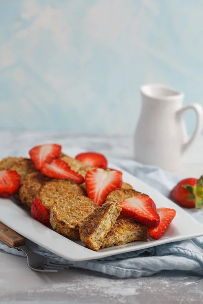 Vegan breakfast sweet tofu fritters (pancakes) with strawberries