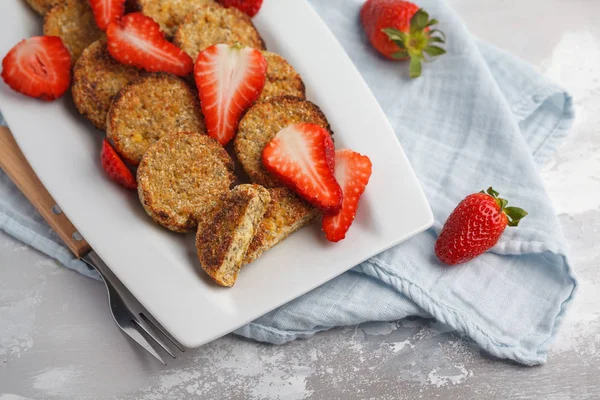 Vegan sweet tofu fritters with strawberries, light background.