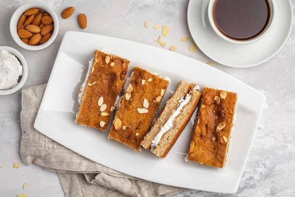 Vegan cake with coconut cream and almonds. Light background